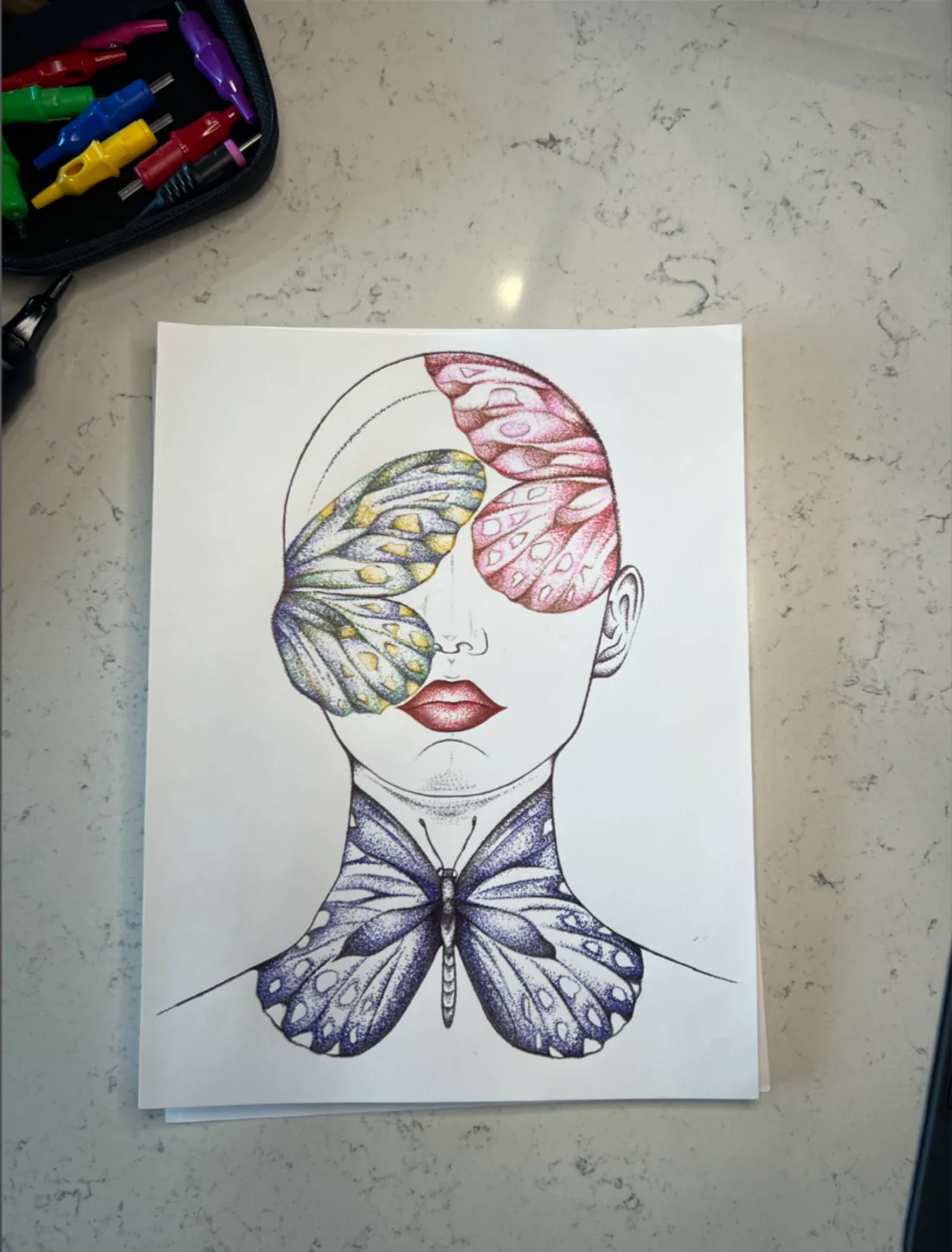 Hand-stippled butterfly face chart on the studio counter
